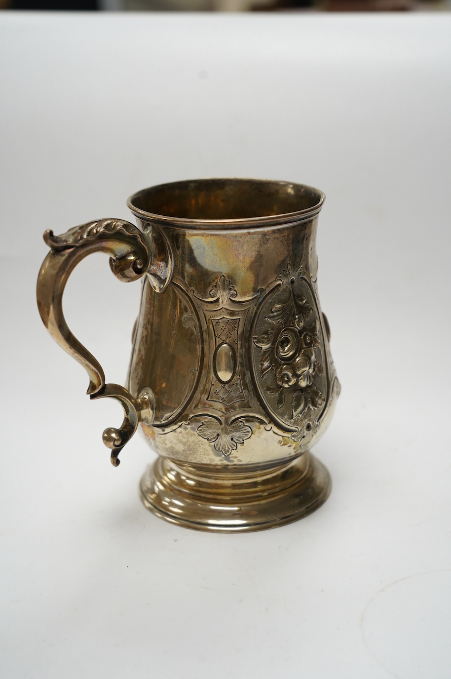 A Victorian repousse silver baluster mug, by Robert Harper, London, 1868, height 13.1cm, 8.9oz. Condition - fair